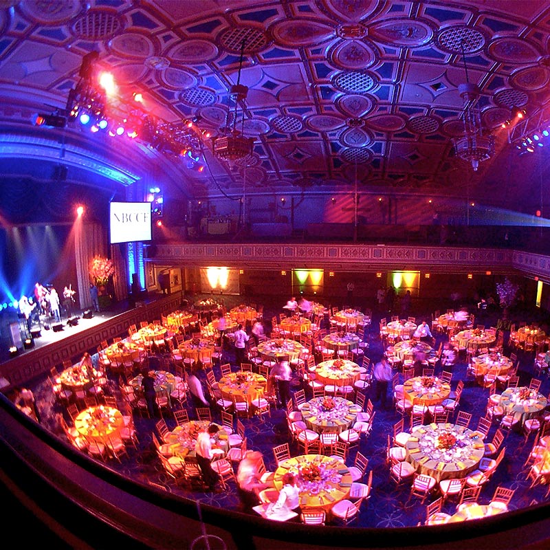 A large room designed for dining, showcasing multiple tables and chairs set up for an upcoming dinner gathering.